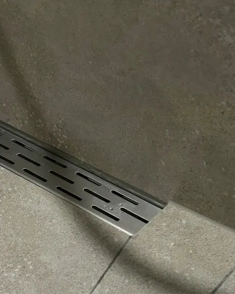 Detail: perfect ingewerkte douchegoot — tegelwerkrenovatie in Nijmegen